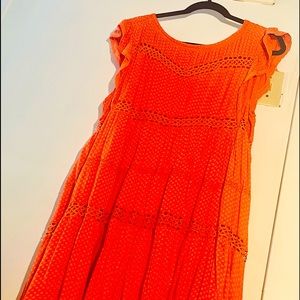 Orange cap sleeve knee length dress with cutouts
